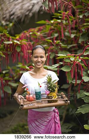 Young Woman Holding Tray With Cocktails, Portrait; Dumaguete, Oriental s Island, Philippines View Large Photo Image Stock Photograph - Young Woman Holding Tray With Cocktails, Portrait; Dumaguete, Oriental s Island, Philippines. Fotosearch