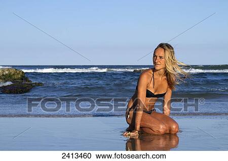 Young woman in a bikini at Seven Mile Beach, Byron Bay; New South Wales, Australia View Large Photo Image Stock Image - Young woman in a bikini at Seven Mile Beach, Byron Bay; New South Wales, Australia. Fotosearch