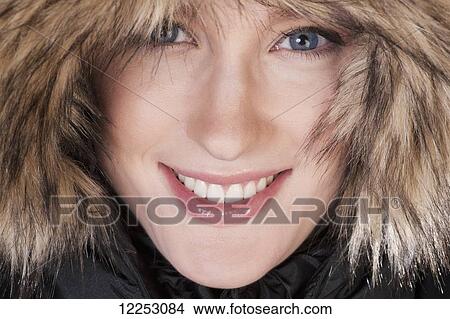 Picture - Young woman in a fur trimmed hood and winter coat; Edmonton, Alberta, Canada. Fotosearch