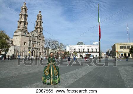 Young Woman In A Traditional Dress On La Patria Square In Front Of The Basilica Cathedral, Aguascalientes, Mexico View Large Photo Image Stock Photography - Young Woman In A Traditional Dress On La Patria Square In Front Of The Basilica Cathedral, Aguascalientes, Mexico. Fotosearch