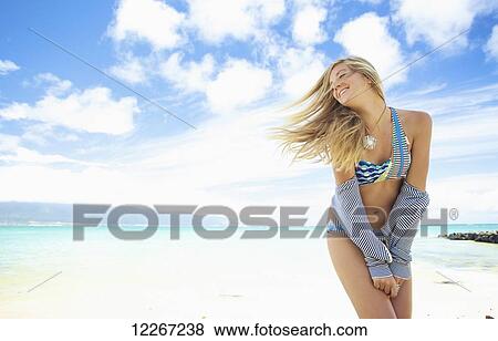 Young woman in bikini on the beach; Kauai, Hawaii, United States of America View Large Photo Image Stock Photo - Young woman in bikini on the beach; Kauai, Hawaii, United States of America. Fotosearch