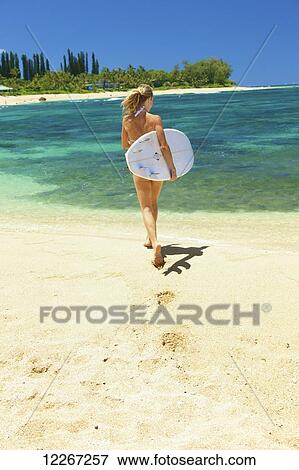 Young woman in bikini with bodyboard on the beach; Kauai, Hawaii, United States of America View Large Photo Image Stock Photo - Young woman in bikini with bodyboard on the beach; Kauai, Hawaii, United States of America. Fotosearch