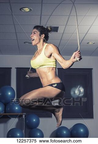 Stock Photography - Young woman jumping rope in a gym; Tarifa, Cadiz, Andalusia, Spain. Fotosearch