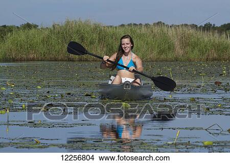 Picture - Young woman kayaking in Upper Myakka River Lake, Myakka River State Park; Sarasota, Florida, United States of America. Fotosearch