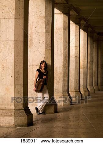 Stock Image - Young Woman Leaning On Column; Rome, Italy. Fotosearch