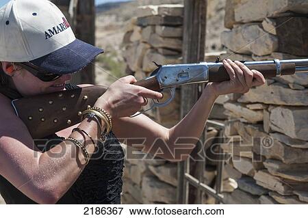 Young Woman Learning How To Fire Shotgun At Lajitas Resort, Big Bend National Park And Big Bend State Park, South West Texas, Usa View Large Photo Image Stock Photo - Young Woman Learning How To Fire Shotgun At Lajitas Resort, Big Bend National Park And Big Bend State Park, South West Texas, Usa. Fotosearch