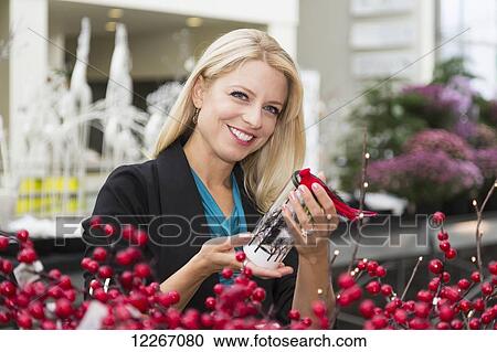 Young woman looking at Christmas decorations at the mall; St. Albert, Alberta, Canada View Large Photo Image Stock Image - Young woman looking at Christmas decorations at the mall; St. Albert, Alberta, Canada. Fotosearch