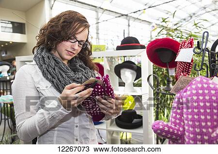 Young woman looking at knitted accessories in the mall; St. Albert, Alberta, Canada View Large Photo Image Stock Image - Young woman looking at knitted accessories in the mall; St. Albert, Alberta, Canada. Fotosearch