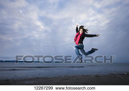 Young woman playing and jumping on the Homer Spit, Kenai Peninsula, Southcentral Alaska View Large Photo Image Stock Photo - Young woman playing and jumping on the Homer Spit, Kenai Peninsula, Southcentral Alaska. Fotosearch