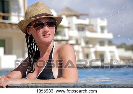 Stock Image - Young Woman Poolside, Cabo San Lucas, Mexico. Fotosearch