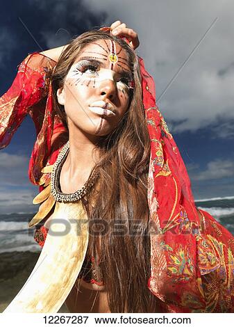 Young woman posing on a beach in a bikini and tribal face paint; Kauai, Hawaii, United States of America View Large Photo Image Stock Photo - Young woman posing on a beach in a bikini and tribal face paint; Kauai, Hawaii, United States of America. Fotosearch