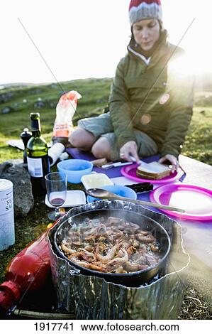 Stock Image - Young Woman Preparing Picnic. Fotosearch