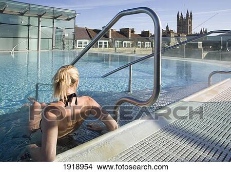 Picture - Young Woman Relaxing In Roof Top Pool,; Thermae Bath Spa, Bath, England. Fotosearch