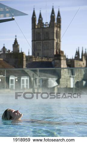Stock Photo - Young Woman Relaxing In Roof Top Pool,; Thermae Bath Spa, Bath, England. Fotosearch