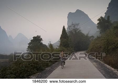 Young Woman Riding Bike In Mountain Area View Large Photo Image Stock Image - Young Woman Riding Bike In Mountain Area. Fotosearch