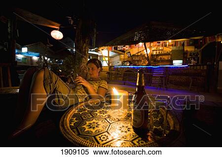 Young Woman Sitting In Bar At Night In Vang Vieng, Laos View Large Photo Image Stock Photography - Young Woman Sitting In Bar At Night In Vang Vieng, Laos. Fotosearch