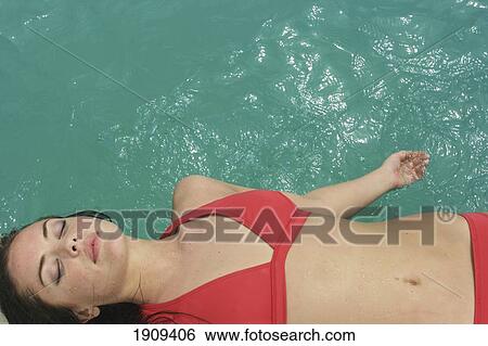 Stock Photograph - Young Woman Sunbathing By Swimming Pool, Mayan Riviera, Yucatan Peninsular, Quintana Roo State, Mexico. Fotosearch
