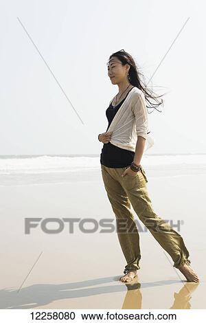 Young woman walking on the beach from HuoHu, North of Kinmen Island; HuoHu, Taiwan View Large Photo Image Stock Image - Young woman walking on the beach from HuoHu, North of Kinmen Island; HuoHu, Taiwan. Fotosearch