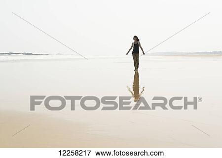 Young woman walking on the beach from HuoHu, North of Kinmen Island; Taiwan View Large Photo Image Stock Photo - Young woman walking on the beach from HuoHu, North of Kinmen Island; Taiwan. Fotosearch
