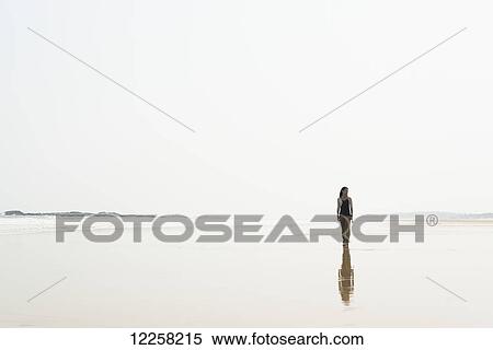 Young woman walking on the beach from HuoHu, North of Kinmen Island; Taiwan View Large Photo Image Stock Photography - Young woman walking on the beach from HuoHu, North of Kinmen Island; Taiwan. Fotosearch