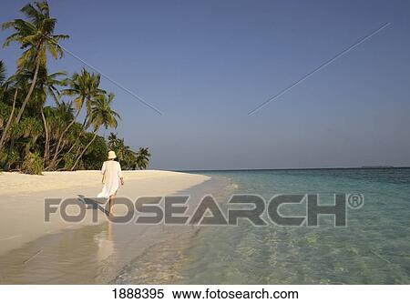 Young Woman Walking On The Beach. View Large Photo Image Stock Photography - Young Woman Walking On The Beach.. Fotosearch
