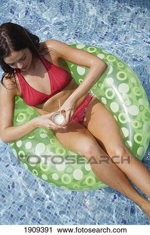 Stock Image - Young Woman Wearing Bikini, Drinking Cocktail In Swimming Pool, Mayan Riviera, Yucatan Peninsular, Quintana Roo State, Mexico. Fotosearch