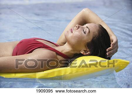 Stock Photography - Young Woman Wearing Bikini, Sunbathing In Swimming Pool, Mayan Riviera, Yucatan Peninsular, Quintana Roo State, Mexico. Fotosearch