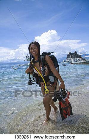 Young Woman With Diving Equipment Standing In Water; Dumaguete, Oriental s Island, Philippines View Large Photo Image Stock Image - Young Woman With Diving Equipment Standing In Water; Dumaguete, Oriental s Island, Philippines. Fotosearch