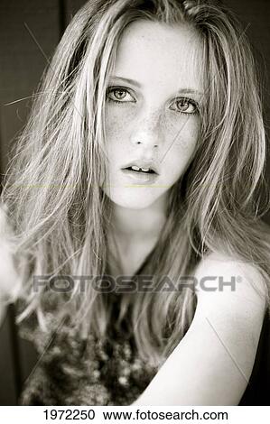 Stock Image - Young Woman With Red Hair And Freckles Poses For Camera.. Fotosearch