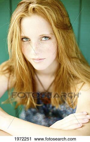 Young Woman With Red Hair And Freckles Crosses Her Arms And Poses. View Large Photo Image Stock Image - Young Woman With Red Hair And Freckles Crosses Her Arms And Poses.. Fotosearch