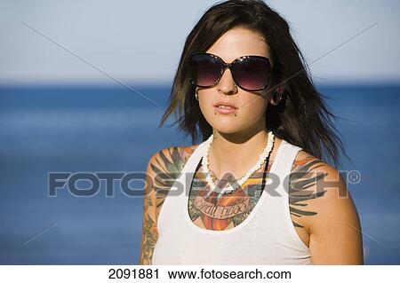Young Woman With Tattoos Sitting By Lake Simcoe; Ontario Canada View Large Photo Image Stock Image - Young Woman With Tattoos Sitting By Lake Simcoe; Ontario Canada. Fotosearch