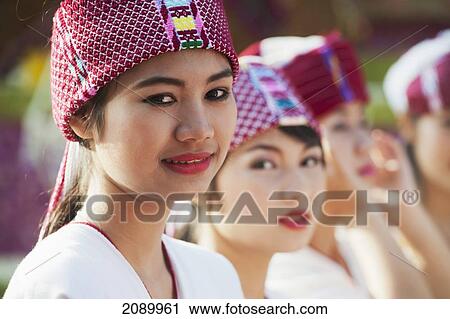 Stock Image - Young Women Dressed For The Chiang Mai Flower Festival Parade; Chiang Mai, Thailand. Fotosearch