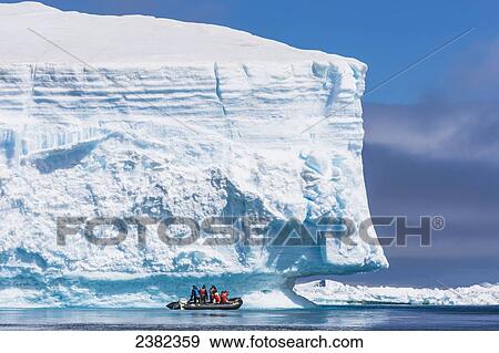 Zodiak ride along a giant iceberg near Paulet Island, Antarctic peninsula; Antarctica View Large Photo Image Stock Photo - Zodiak ride along a giant iceberg near Paulet Island, Antarctic peninsula; Antarctica. Fotosearch