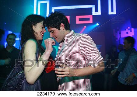 Stock Photo - Zoe Griffin enjoys a dance with local boys at Push Club, Riga, Latvia.. Fotosearch