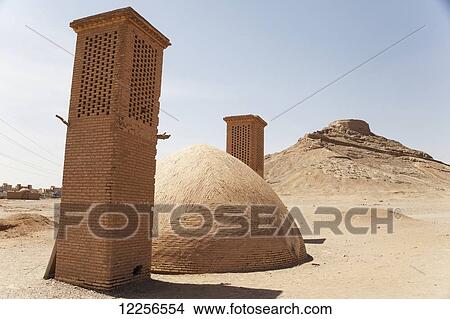 Zoroastrian Tower of Silence (Dakhmeh) and wind towers of water cistern; Yazd, Iran View Large Photo Image Picture - Zoroastrian Tower of Silence (Dakhmeh) and wind towers of water cistern; Yazd, Iran. Fotosearch