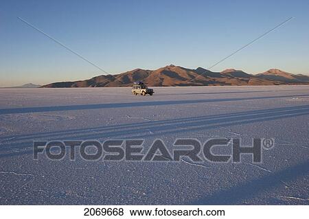 Stock Photo - 4X4 Vehicle In The Salar De Uyuni, The World's Largest Salt Flat At Sunrise, Potosi Department, Bolivia. Fotosearch