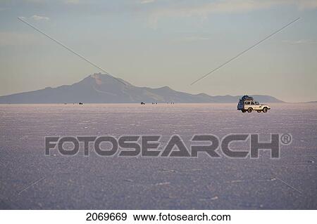 Stock Photo - 4X4 Vehicle In The Salar De Uyuni, The World's Largest Salt Flat At Sunrise, Potosi Department, Bolivia. Fotosearch