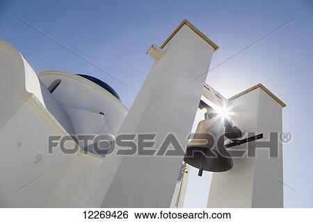 Stock Photograph - A bell tower with a sunburst behind; Paphos, Cyprus. Fotosearch