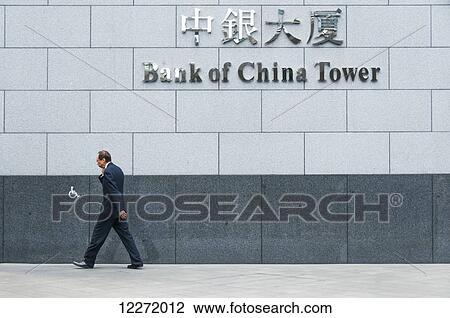 A businessman walking in front of the Bank of China building; Hong Kong, China View Large Photo Image Stock Image - A businessman walking in front of the Bank of China building; Hong Kong, China. Fotosearch