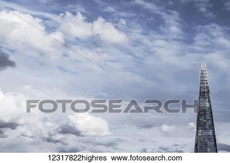 Stock Photograph - A close up view of The Shard and a nearby helicopter, taken from Millennium Bridge; London, England. Fotosearch