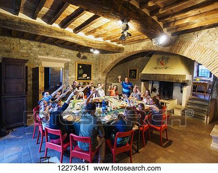 A family makes a familiar Italian dinner toast, A la famiglia, as they celebrate their Tuscan vacation at the villa Fattoria la Nutrice; Capanuccia, Florence, Italy View Large Photo Image Stock Image - A family makes a familiar Italian dinner toast, A la famiglia, as they celebrate their Tuscan vacation at the villa Fattoria la Nutrice; Capanuccia, Florence, Italy. Fotosearch