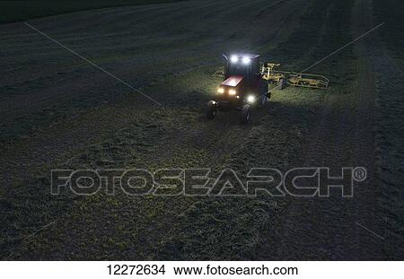 A farmer teds his alfalfa late into the evening, working by LED and standard lights; Crawfordsville, Indiana, United States of America View Large Photo Image Picture - A farmer teds his alfalfa late into the evening, working by LED and standard lights; Crawfordsville, Indiana, United States of America. Fotosearch
