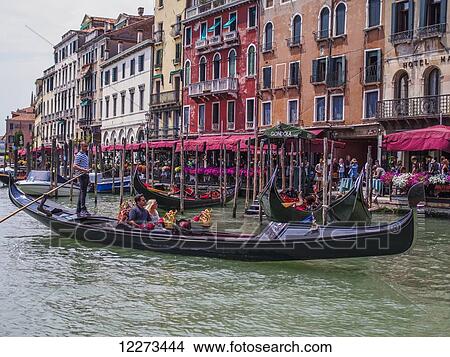 Picture - A gondolier maneuvers his gondola on the Grand Canal; Venice, Italy. Fotosearch