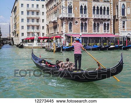 A gondolier maneuvers his gondola on the Grand Canal; Venice, Italy View Large Photo Image Stock Photography - A gondolier maneuvers his gondola on the Grand Canal; Venice, Italy. Fotosearch