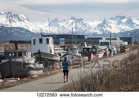 A Homer resident jogs on a path with Homer Spit and the Kenai Mountains in the background, Kenai Peninsula, Southcentral Alaska, Autumn View Large Photo Image Stock Image - A Homer resident jogs on a path with Homer Spit and the Kenai Mountains in the background, Kenai Peninsula, Southcentral Alaska, Autumn. Fotosearch