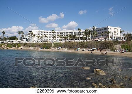 A hotel and palm trees and people on the beach; Paphos, Cyprus View Large Photo Image Stock Photography - A hotel and palm trees and people on the beach; Paphos, Cyprus. Fotosearch