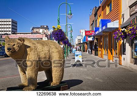 Stock Photo - A large stuffed bear on 4th Ave in downtown Anchorage under blue sky, Southcentral Alaska, Summer.. Fotosearch
