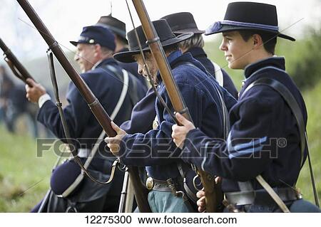A line of American Civil War union re-enactors on the battlefield with guns at the ready; United States of America View Large Photo Image Stock Image - A line of American Civil War union re-enactors on the battlefield with guns at the ready; United States of America. Fotosearch