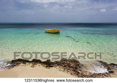 Stock Photograph - A lone boat in the turquoise water off a tropical island; Frederiksted, St. Croix, Virgin Islands, United States of America. Fotosearch