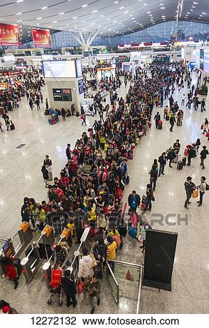 Stock Image - A long line waiting for the train in Shenzhen Train Station; Guangdong, China. Fotosearch